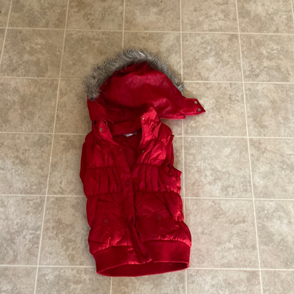 Puffer style button down vest with detachable fur lined hood